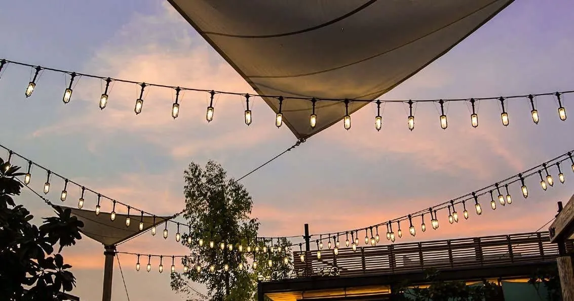 Festoon lighting under a sail canopy