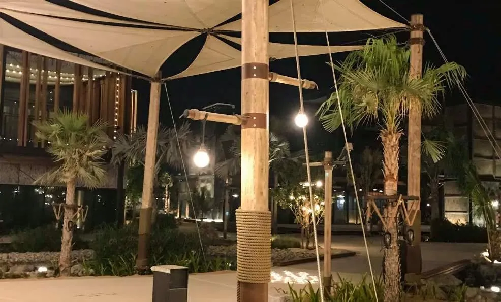 Sail canopies & bamboo poles at dusk
